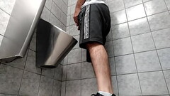 A busy guy with an uncut dick peeing in a public toilet Thumb